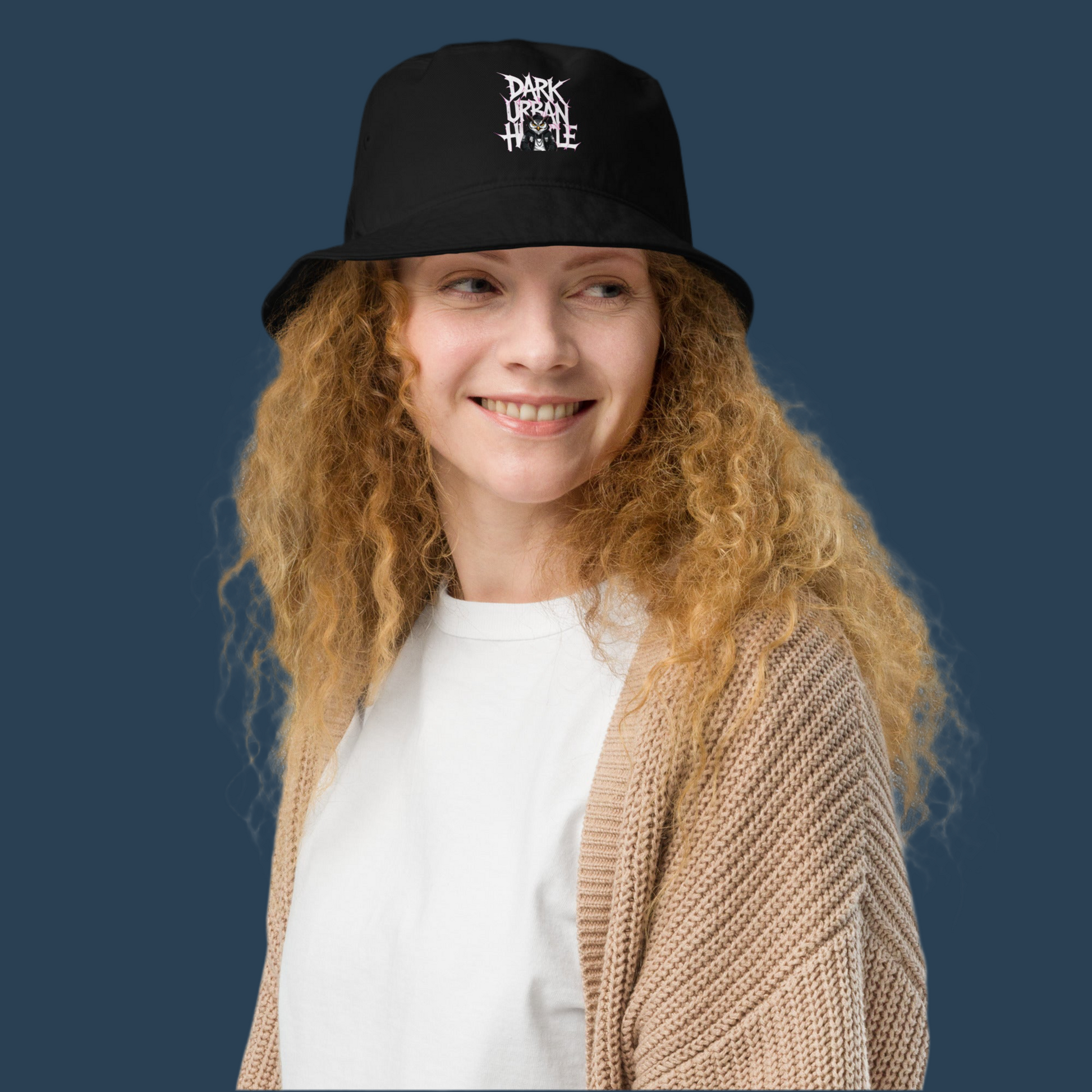 Model wearing the βDark Urban Hustleβ organic bucket hat with premium white embroidery and streetwear design β FGH Collective exclusive.