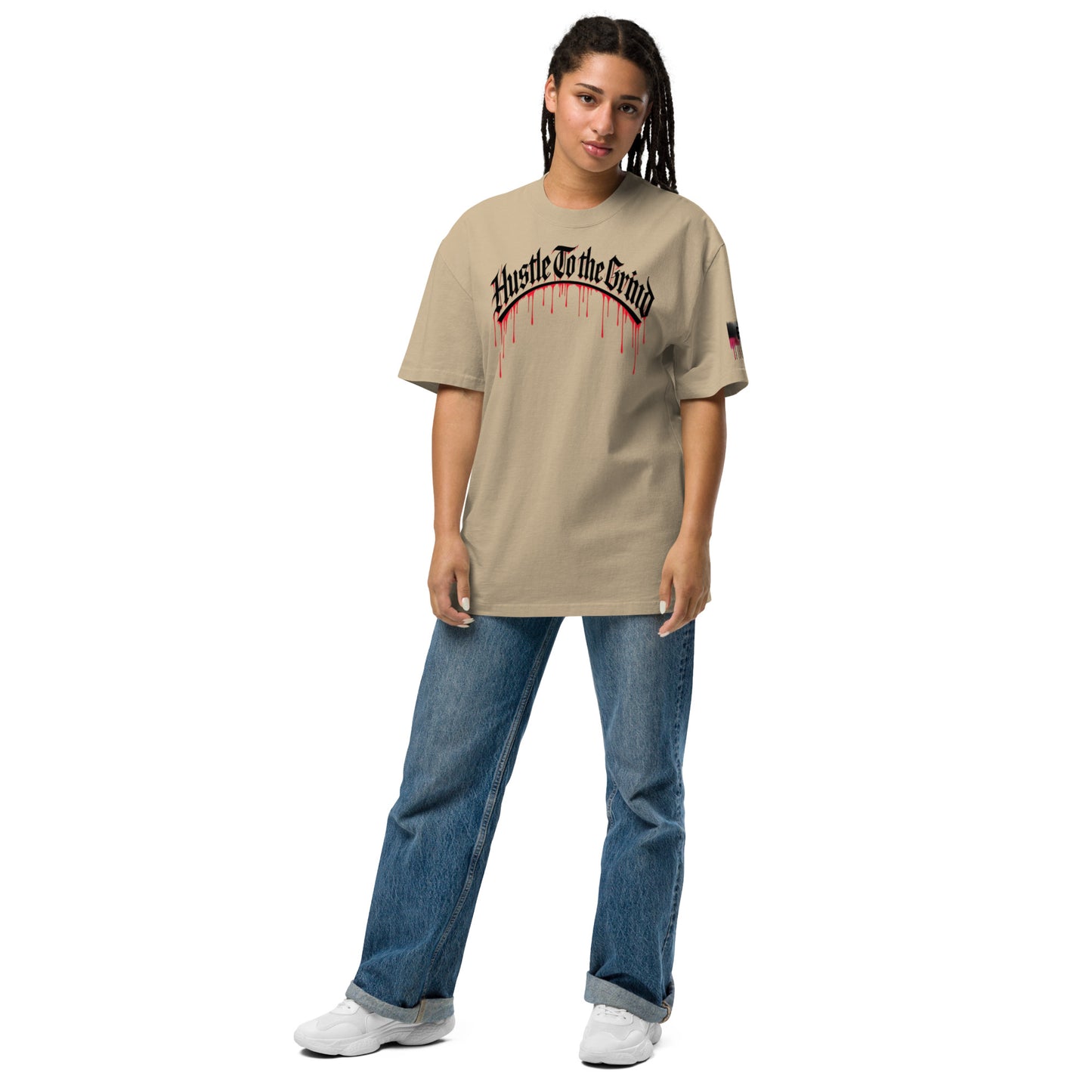 Oversized unisex T-shirt in faded bone color, featuring “Hustle to the Grind” streetwear graphic.