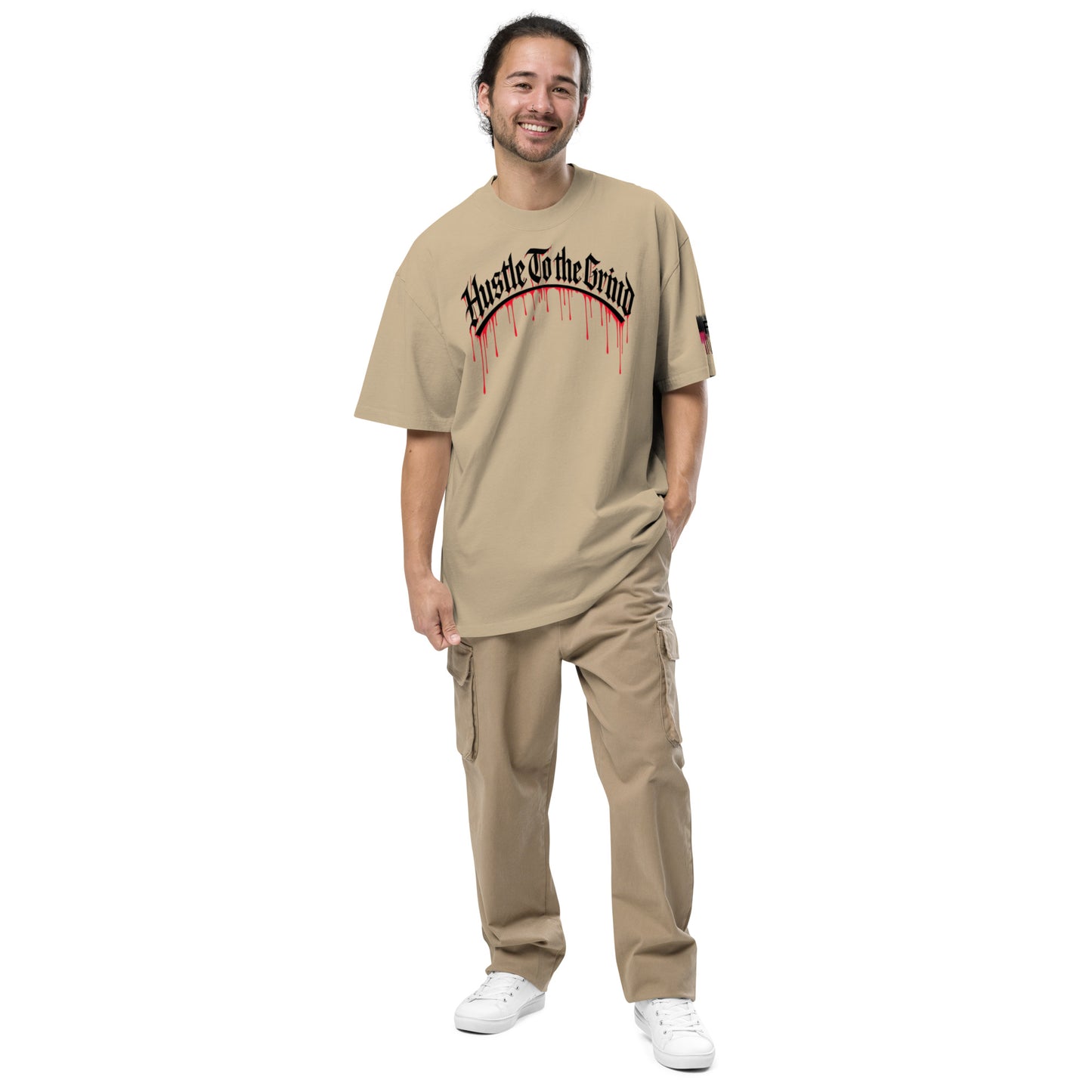 Oversized unisex T-shirt in faded bone color, featuring “Hustle to the Grind” streetwear graphic.