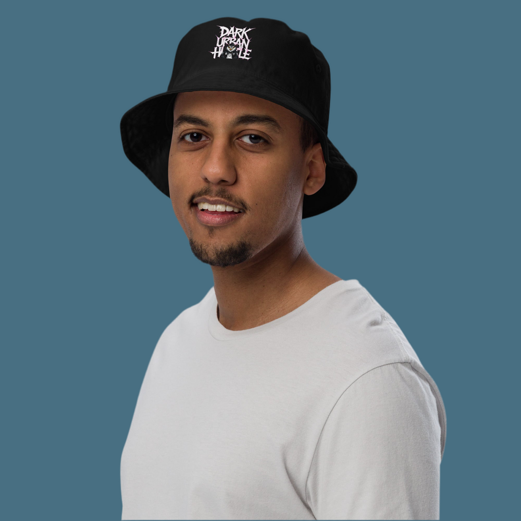 Model wearing the “Dark Urban Hustle” organic bucket hat with premium white embroidery and streetwear design – FGH Collective exclusive.