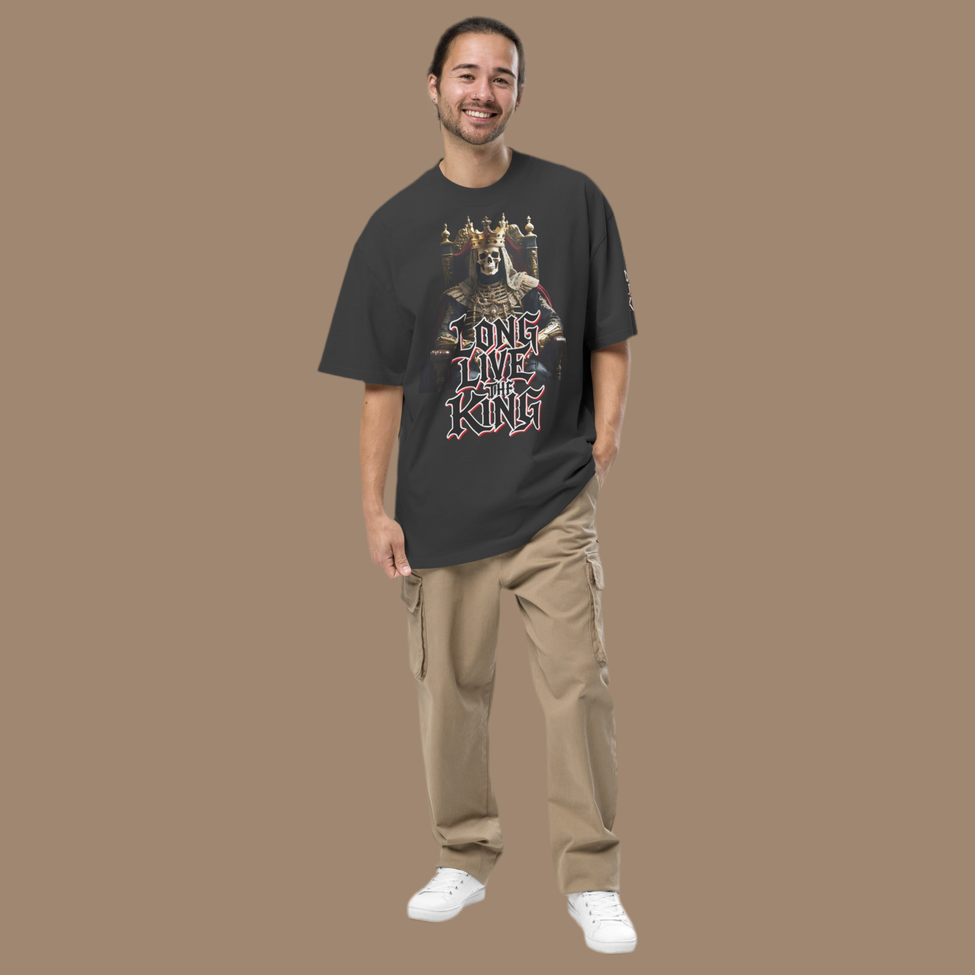 Front view of oversized gothic-style t-shirt featuring a crowned skeleton king on a throne with the graffiti text “Long Live The King” in red, white, and black