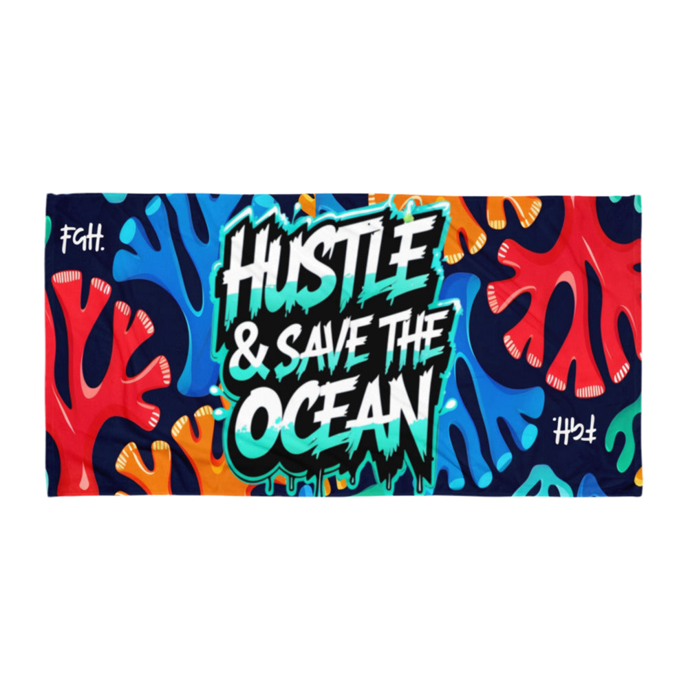 Colorful graffiti-style beach towel with the slogan "Hustle & Save the Ocean", held up by a person on a sunny beach with ocean waves in the background