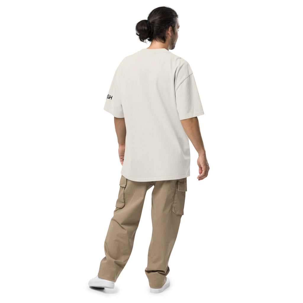 Oversized unisex “Hustle To the Grind” T-shirt in faded white, showcasing urban graffiti streetwear design.