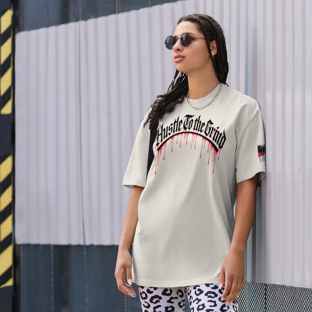 Oversized unisex “Hustle To the Grind” T-shirt in faded white, showcasing urban graffiti streetwear design.