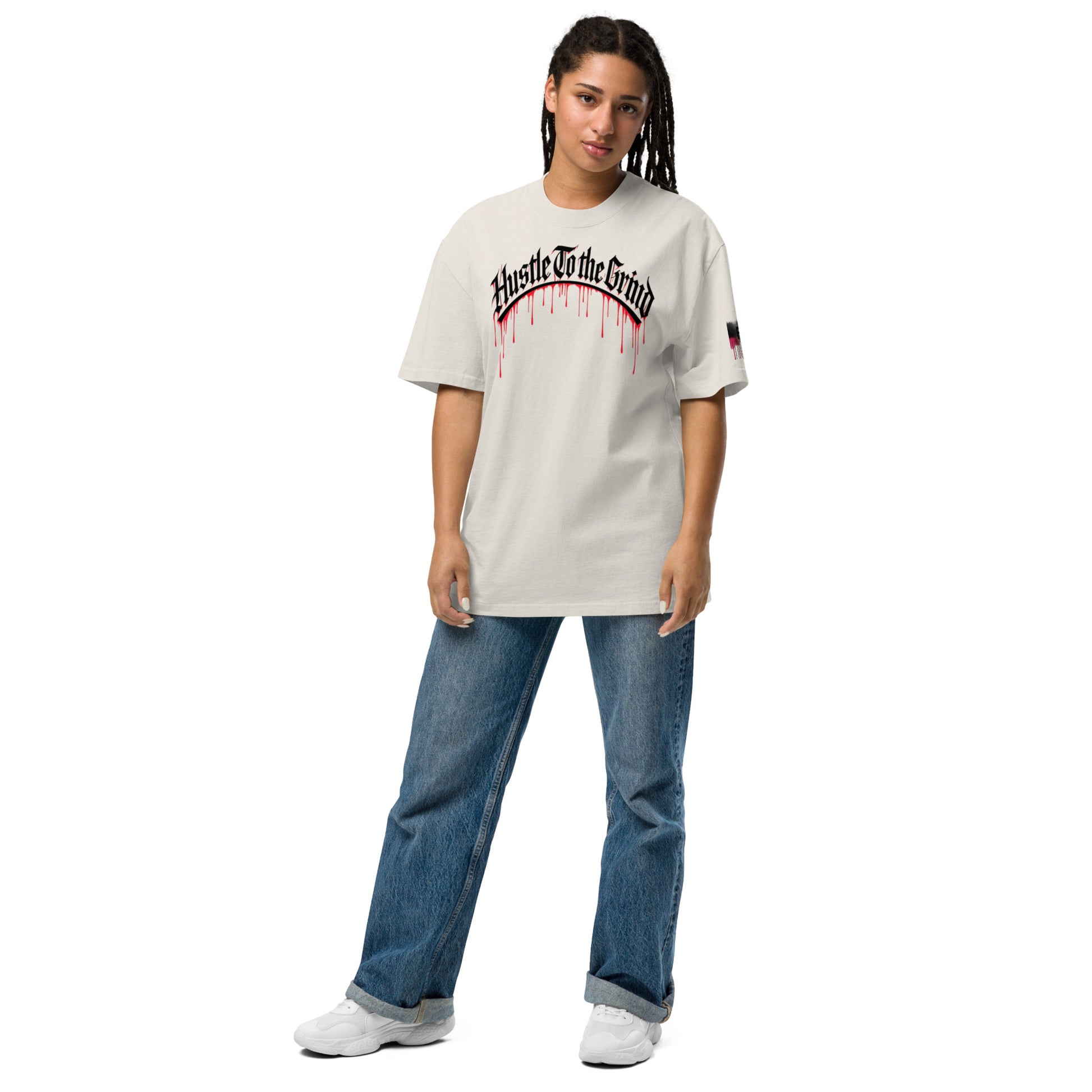 Oversized unisex “Hustle To the Grind” T-shirt in faded white, showcasing urban graffiti streetwear design.