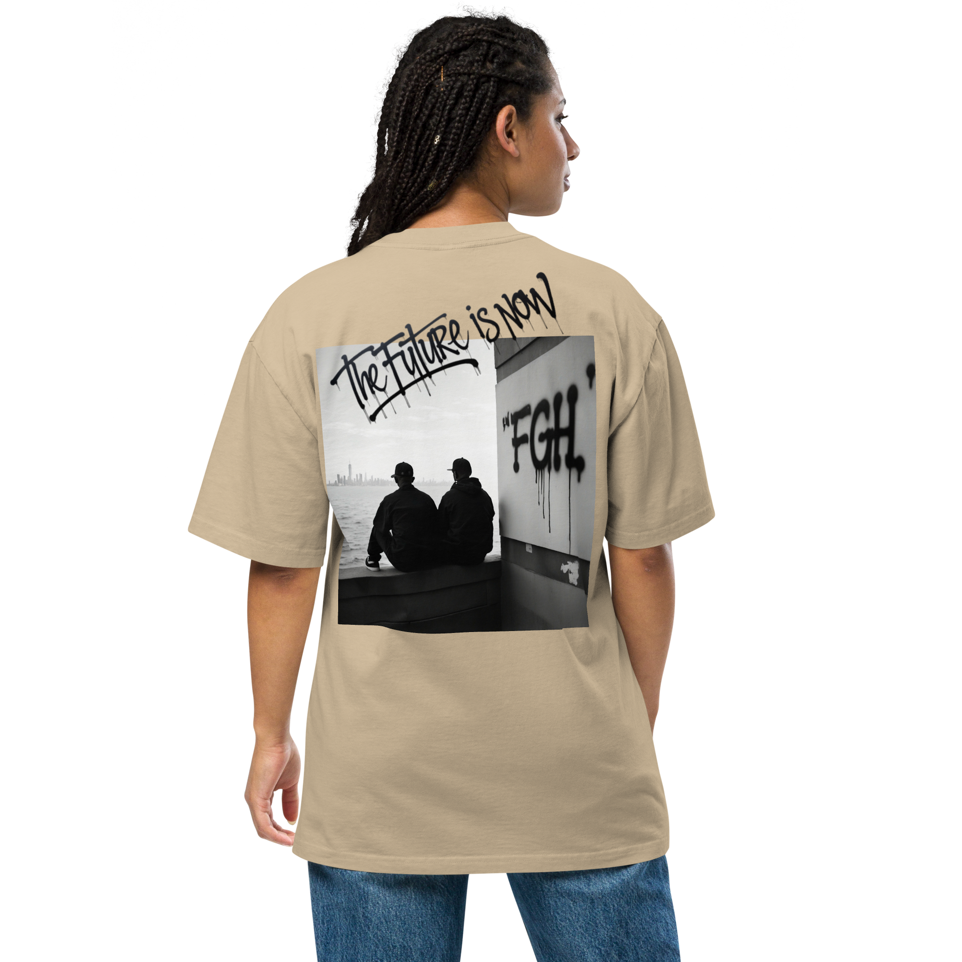 Two men in oversized faded t-shirts sitting by the waterfront, with bold FGH graffiti and a city skyline in the background – urban streetwear aesthetic.