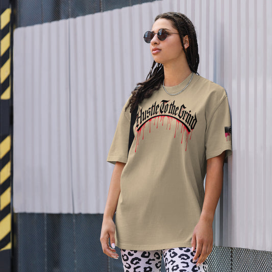 Oversized unisex T-shirt in faded bone color, featuring “Hustle to the Grind” streetwear graphic.